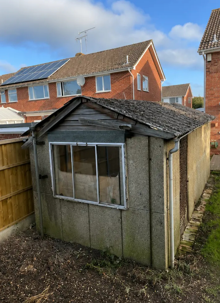Before garage demolition in Chester showing detached concrete garage before demolition by Quirks Property Maintenance Ltd