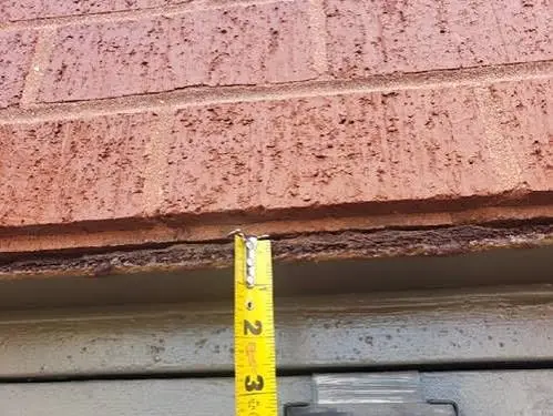 Corroded steel lintel with rust staining on a Victorian terrace in Wallasey, Wirral