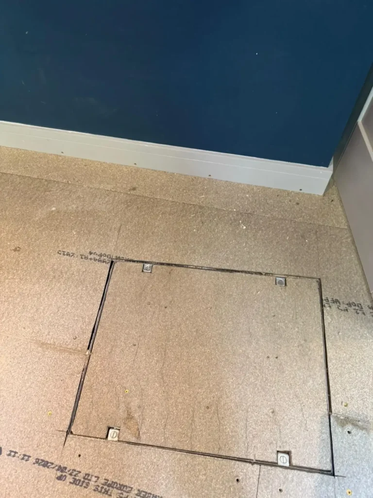 Emergency builder finishing internal drainage inspection chamber in Flintshire