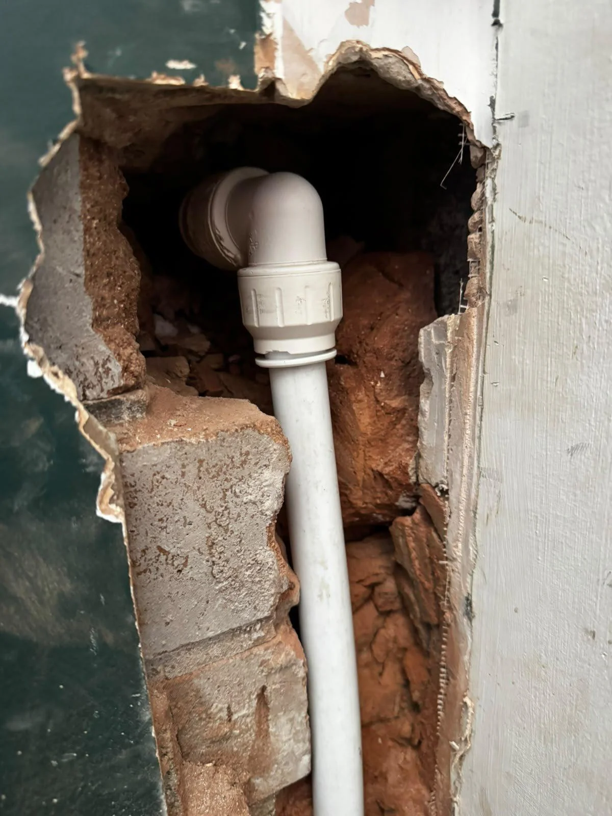 New pipework on push-fit fittings installed in an opened wall to replace a failed copper hot feed