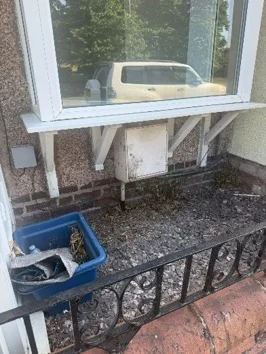 Raised external ground levels bridging the damp proof course at a property in Flintshire