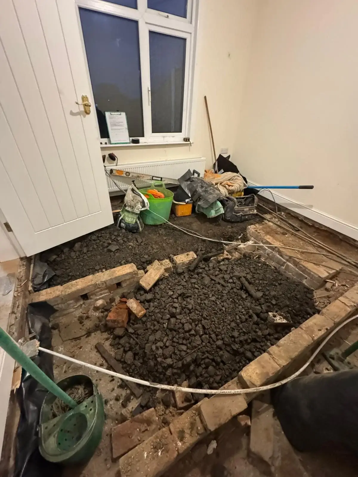 Collapsed floor excavation exposing failed floor structure for repairs