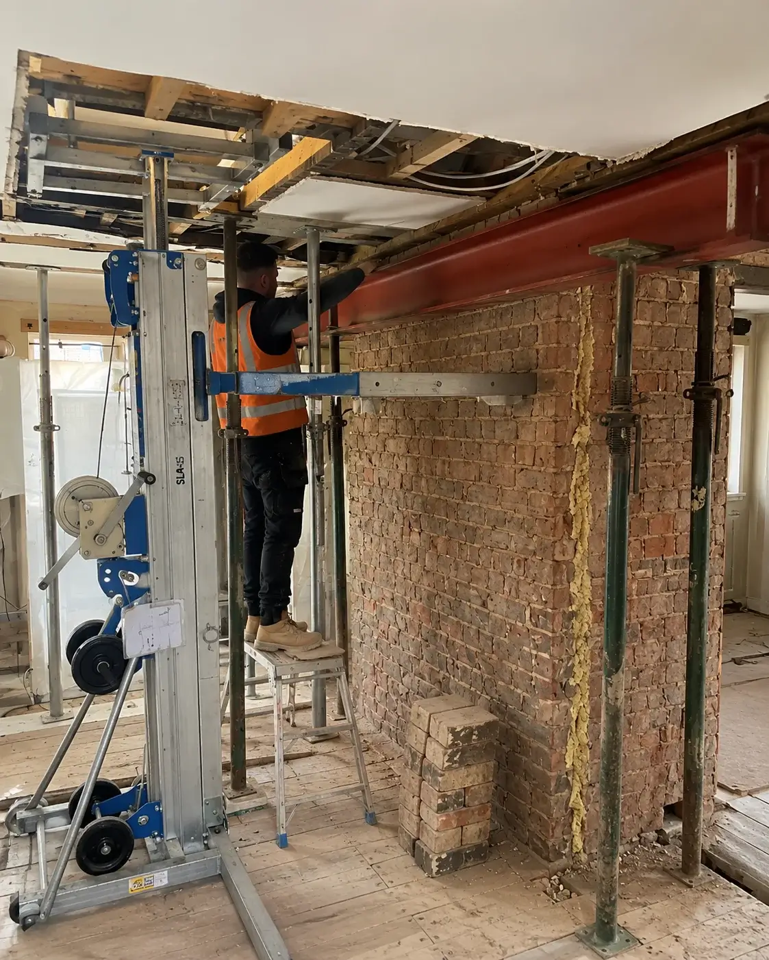 Home extension construction with steel beam fitting and temporary supports