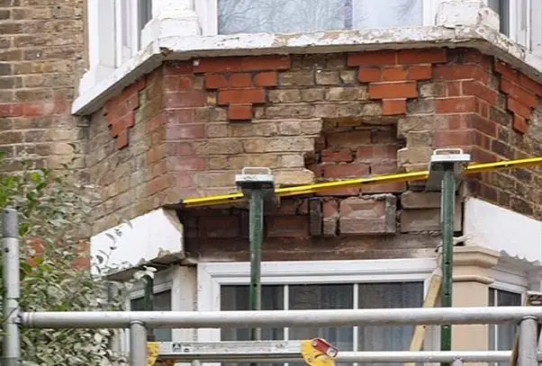 Cracked lintel above a window showing stepped brickwork cracking