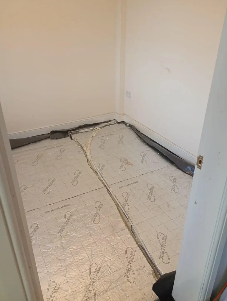 New insulation and service pipes installed beneath the reconstructed floor, Aston, Flintshire