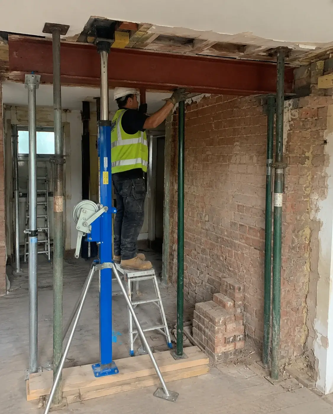 RSJ steel beam installation with temporary supports in residential property
