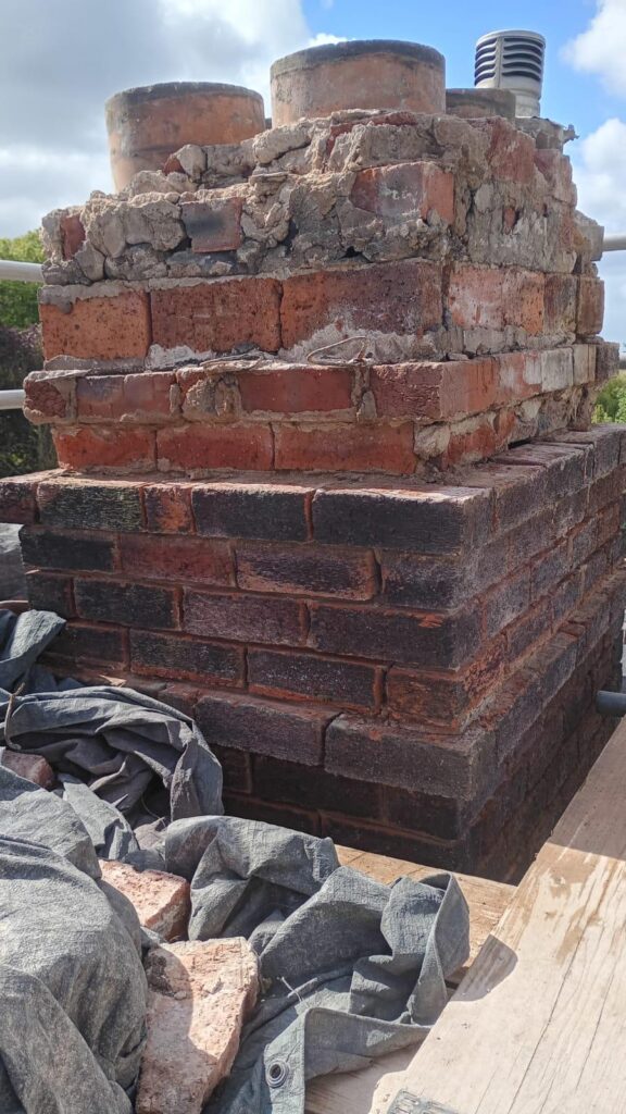Chimney stack repair with damaged brickwork reduced in Flintshire