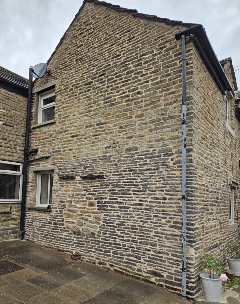 Stone gable of a cottage in Thurstaston, Wirral after repointing in NHL 3.5 hydraulic lime mortar
