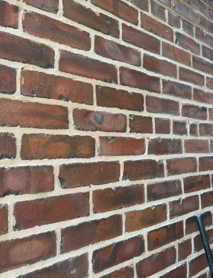 Newly repointed brickwork in NHL 3.5 hydraulic lime mortar with a traditional brushed joint finish