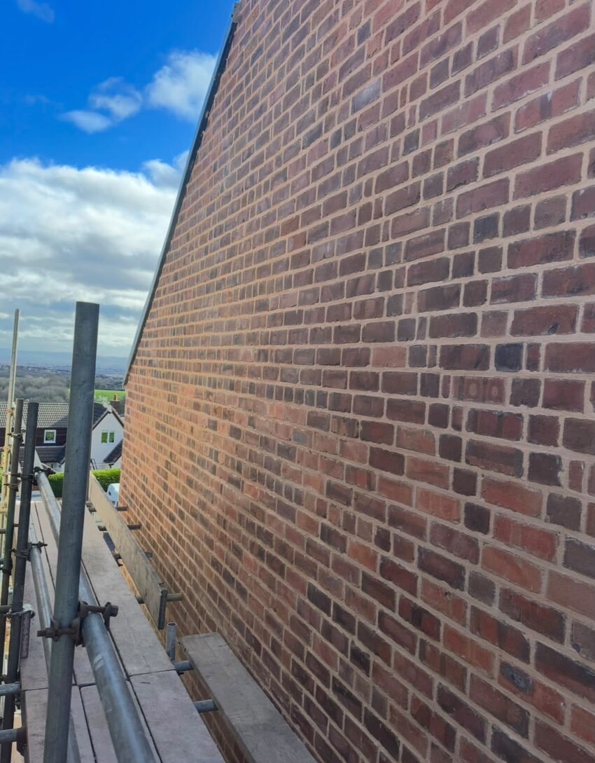 Fully repointed gable elevation in lime mortar, viewed from the scaffold