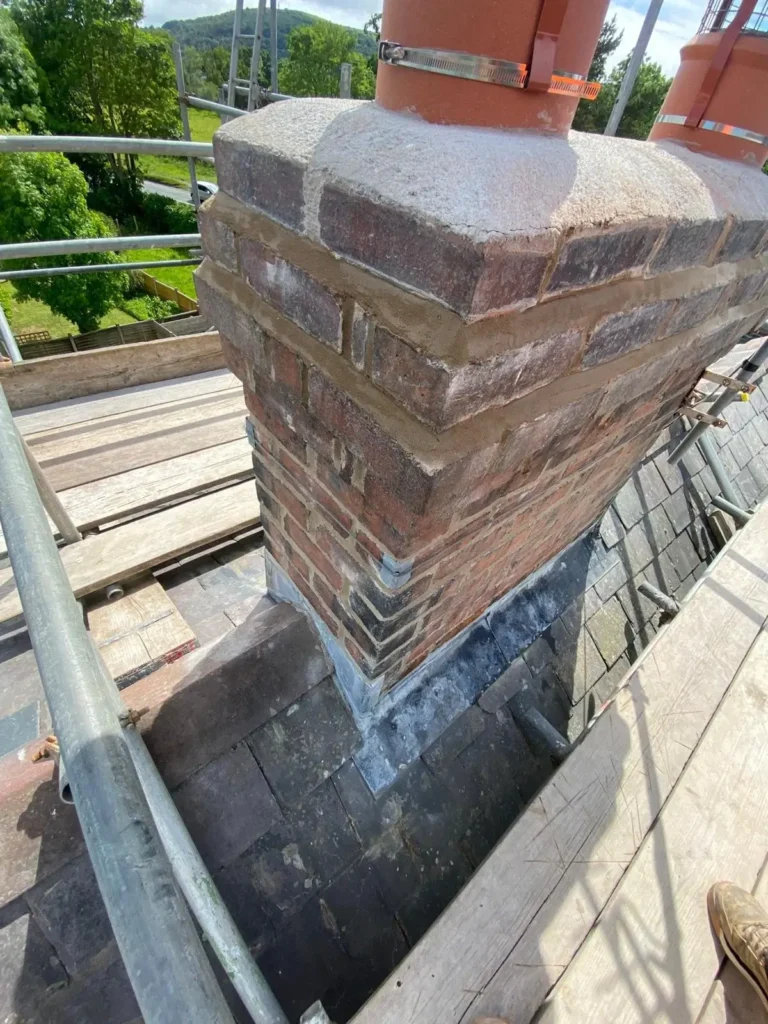 Chimney repointing and chimney crown repairs completed as part of damp remedial works in Hope, Flintshire