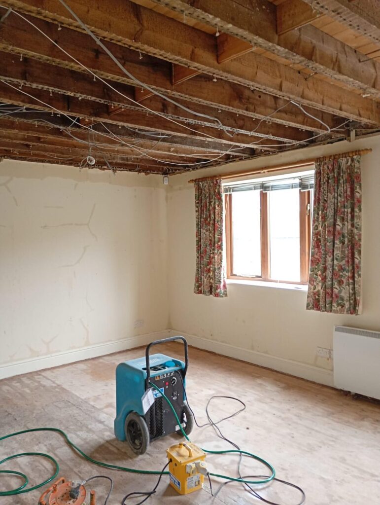 Flood-damaged room stripped out and prepared for controlled drying before reinstatement