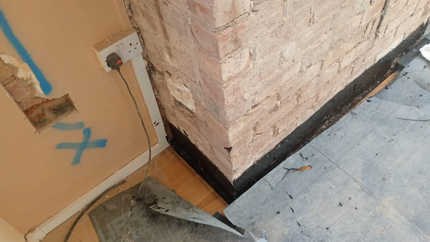 Chimney base prepared for damp treatment in Heswall, Wirral