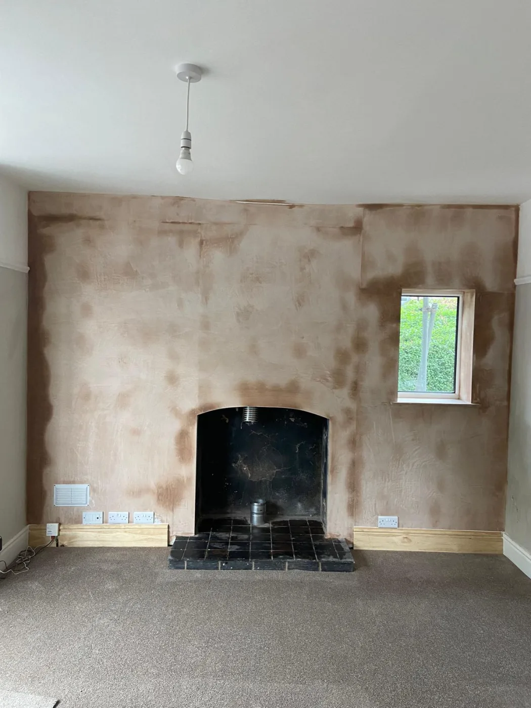 Chimney breast replastered after damp proofing in Flintshire