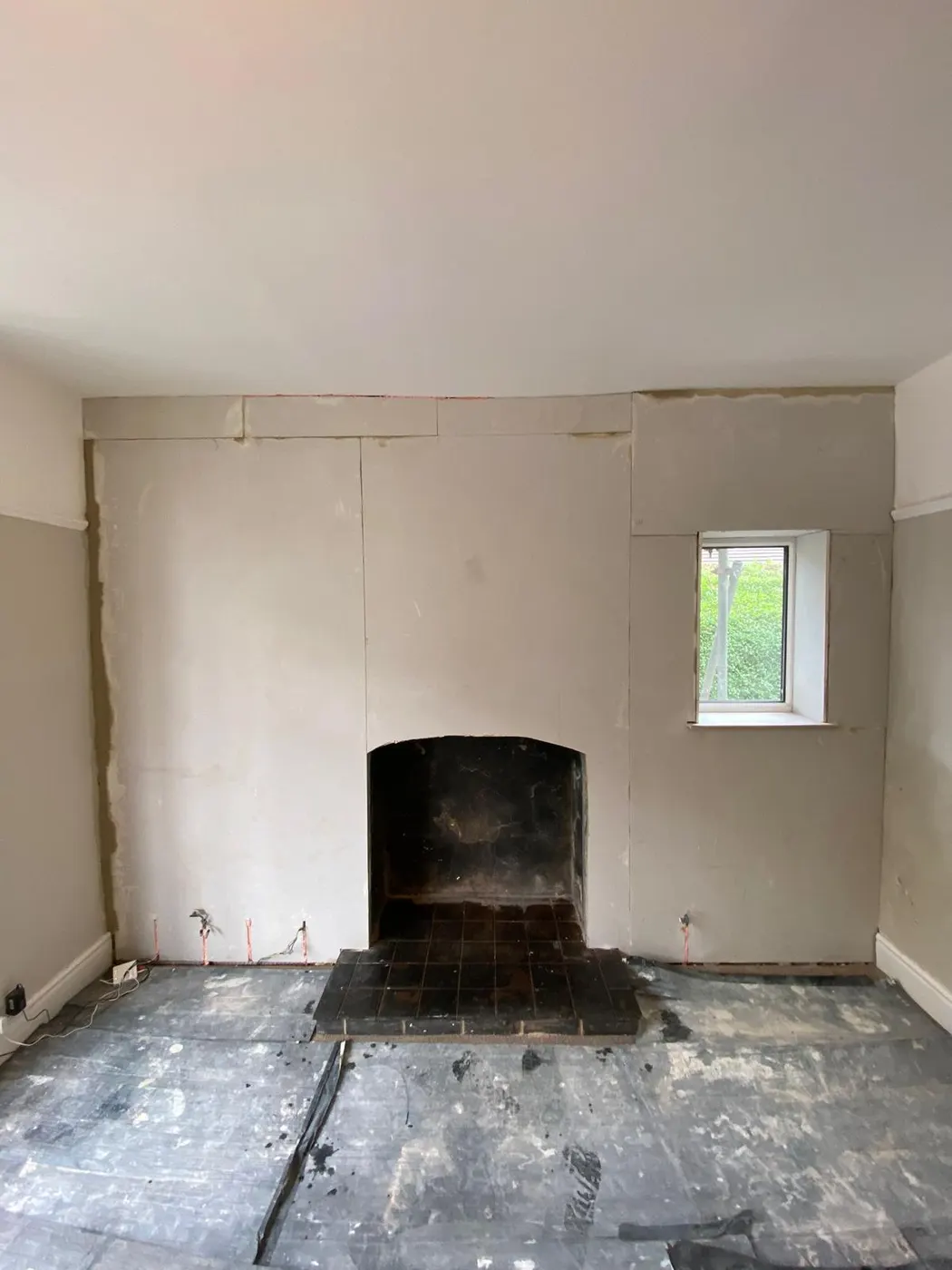 Chimney breast replastered after damp proofing in Flintshire