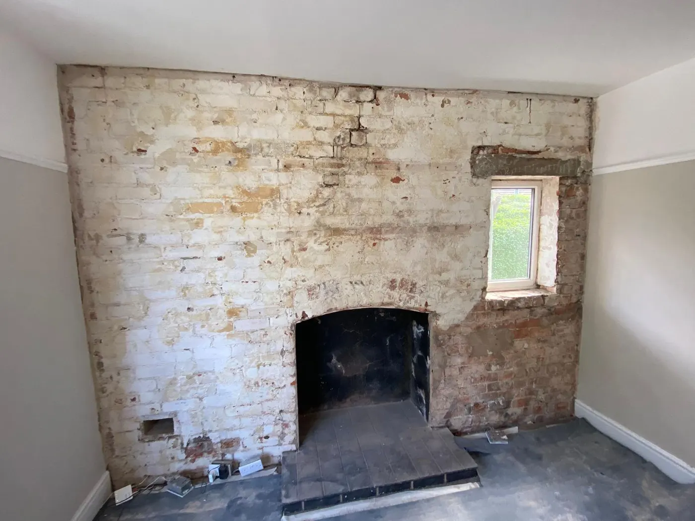 Chimney breast stripped back to brick during damp proofing in Flintshire
