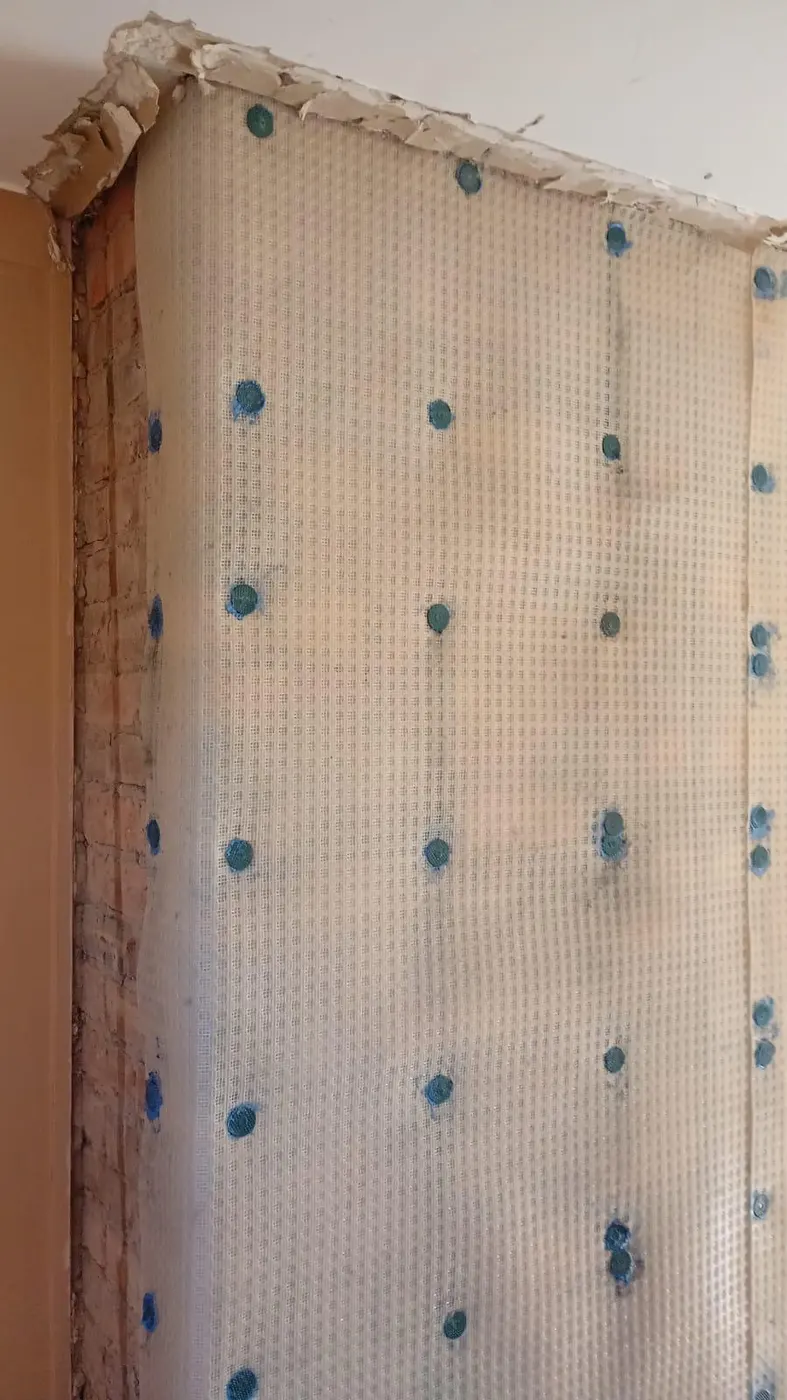 Damp-proof membrane fixed to the chimney breast in Heswall, Wirral
