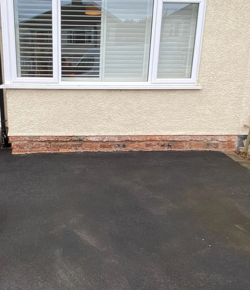 Brickwork below the damp proof course with the coating removed at a Chester home