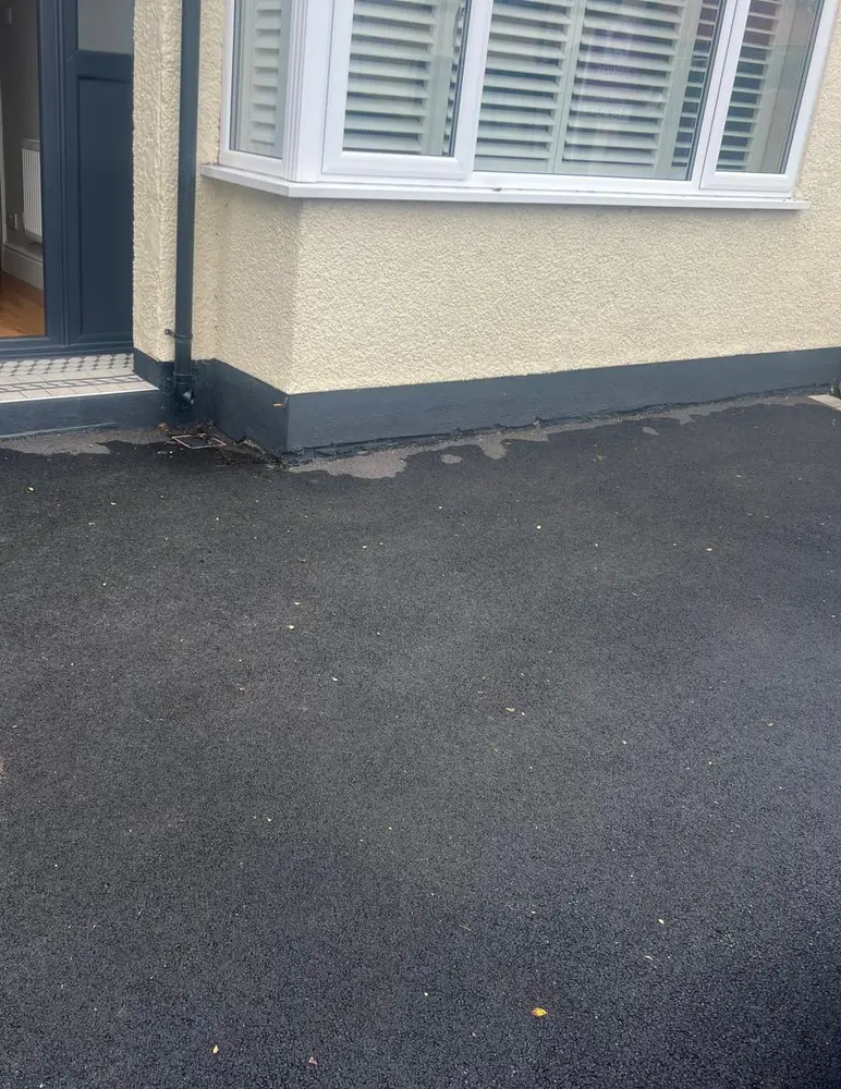 Painted brickwork below the damp proof course at a Chester home before damp proofing