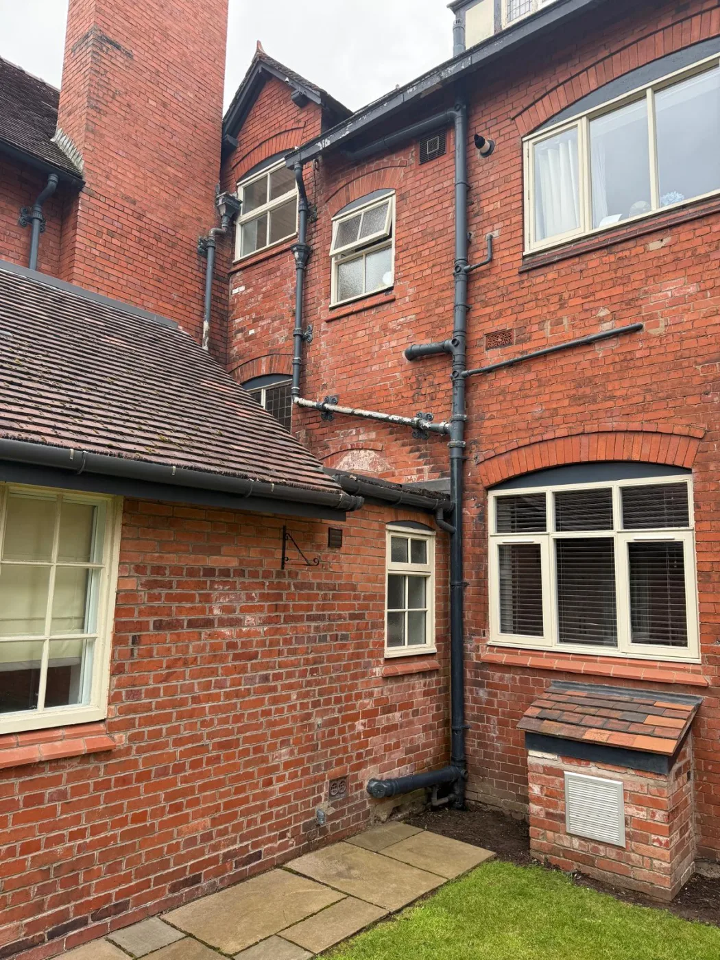Rear elevation brickwork and rainwater goods on a property affected by penetrating damp