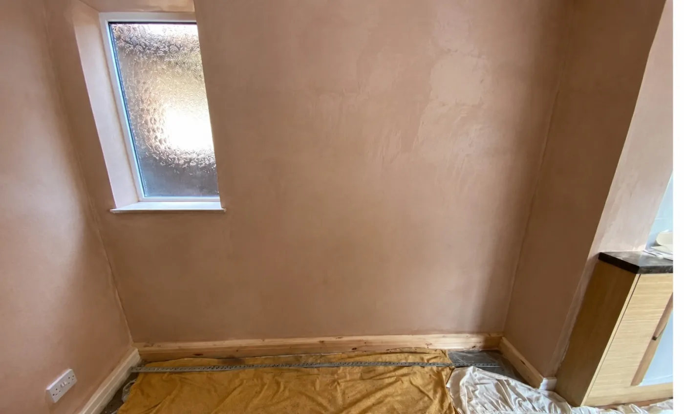Reinstated wall with new skirting after damp proofing in Deeside