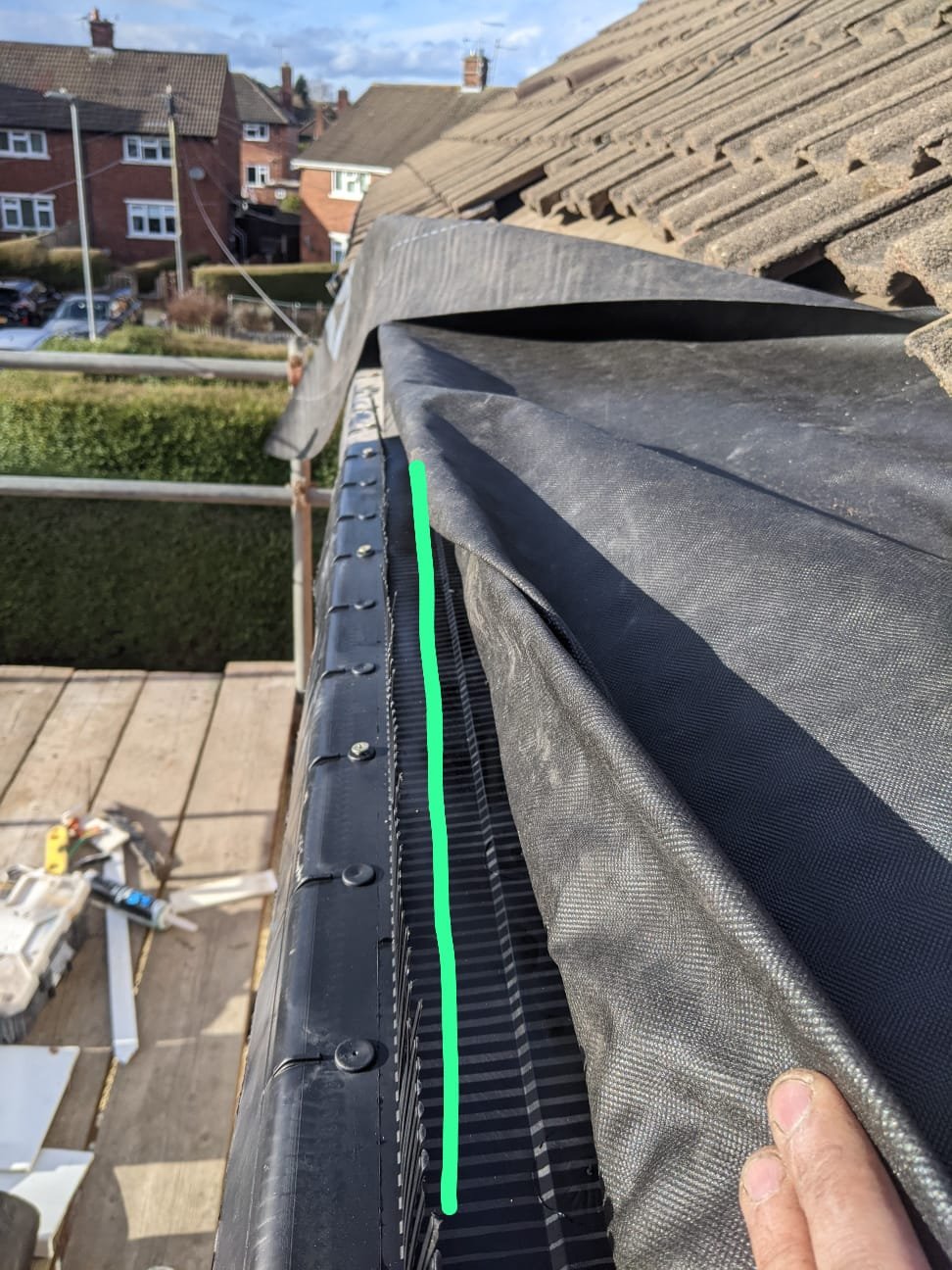 New eaves protection tray in place with the underlay dressed over it, discharging into the gutter