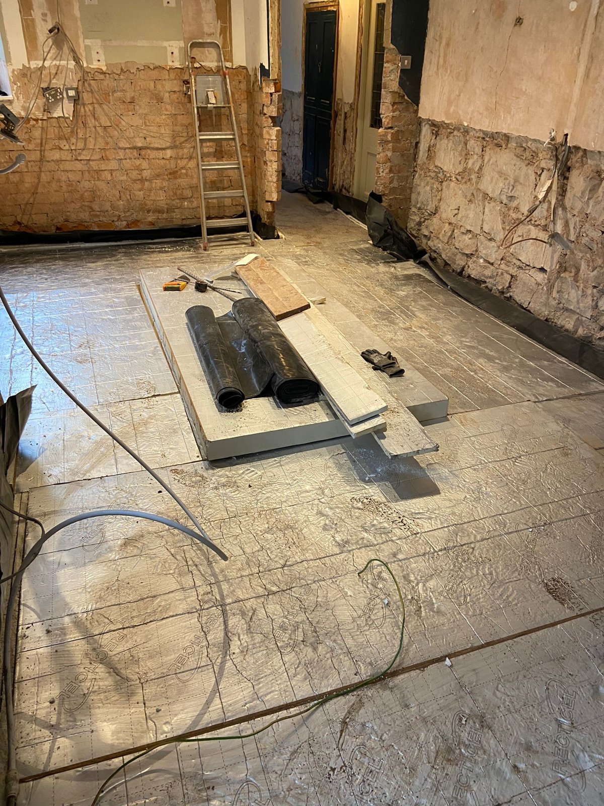 Foil-faced insulation boards laid over a damp-proof membrane as part of a new solid floor build-up