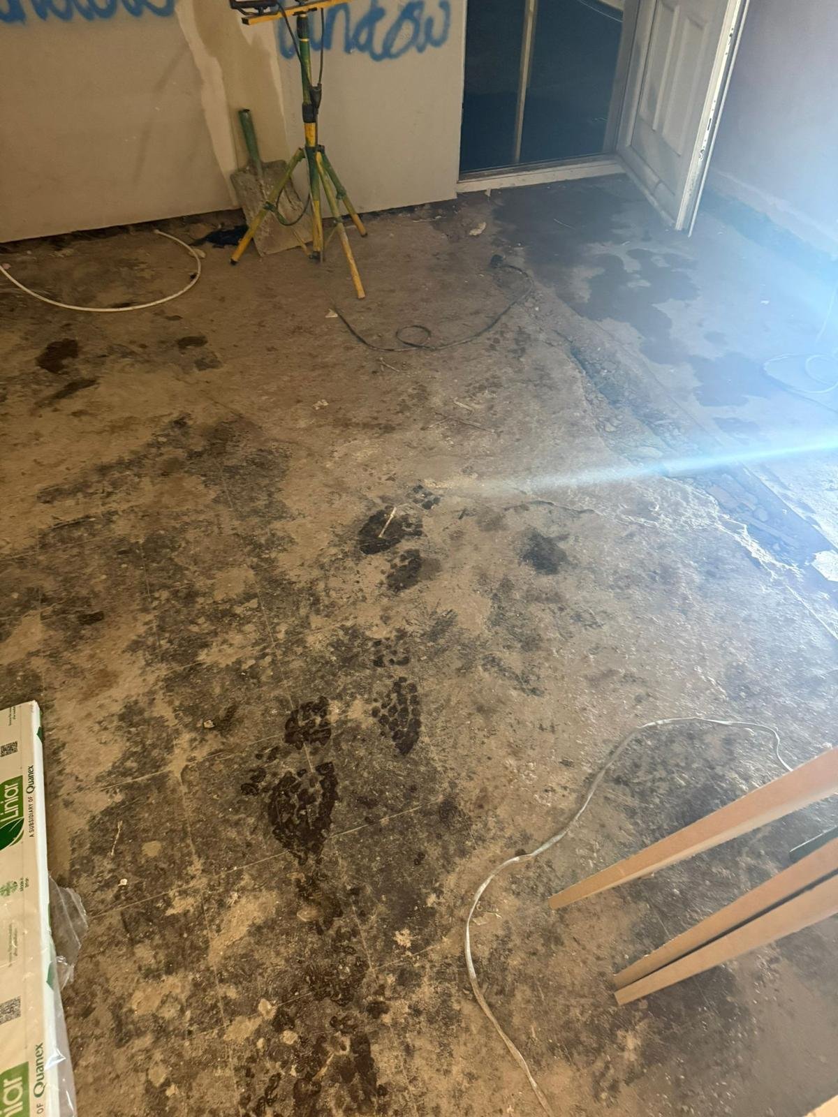 Old solid floor in a house under renovation with coverings removed ready for a liquid damp-proof membrane