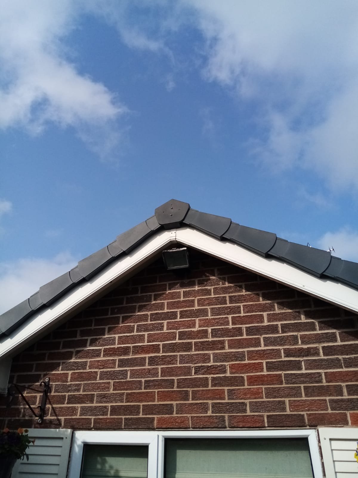 Anthracite dry verge units fitted along both sides of a gable and closed off at the apex