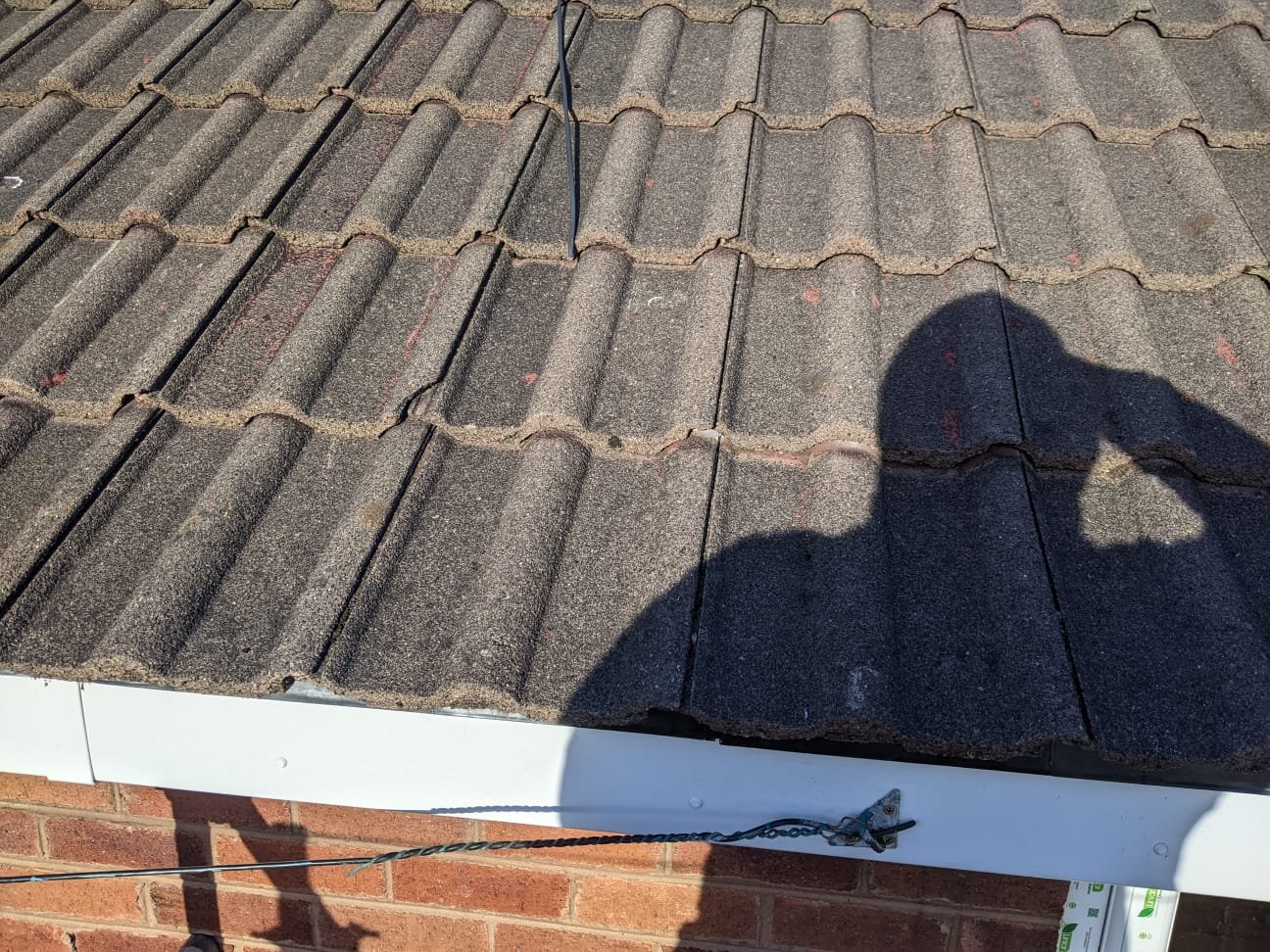Completed eaves on a Connah's Quay semi-detached house with a new fascia and the bottom courses of tiles reset