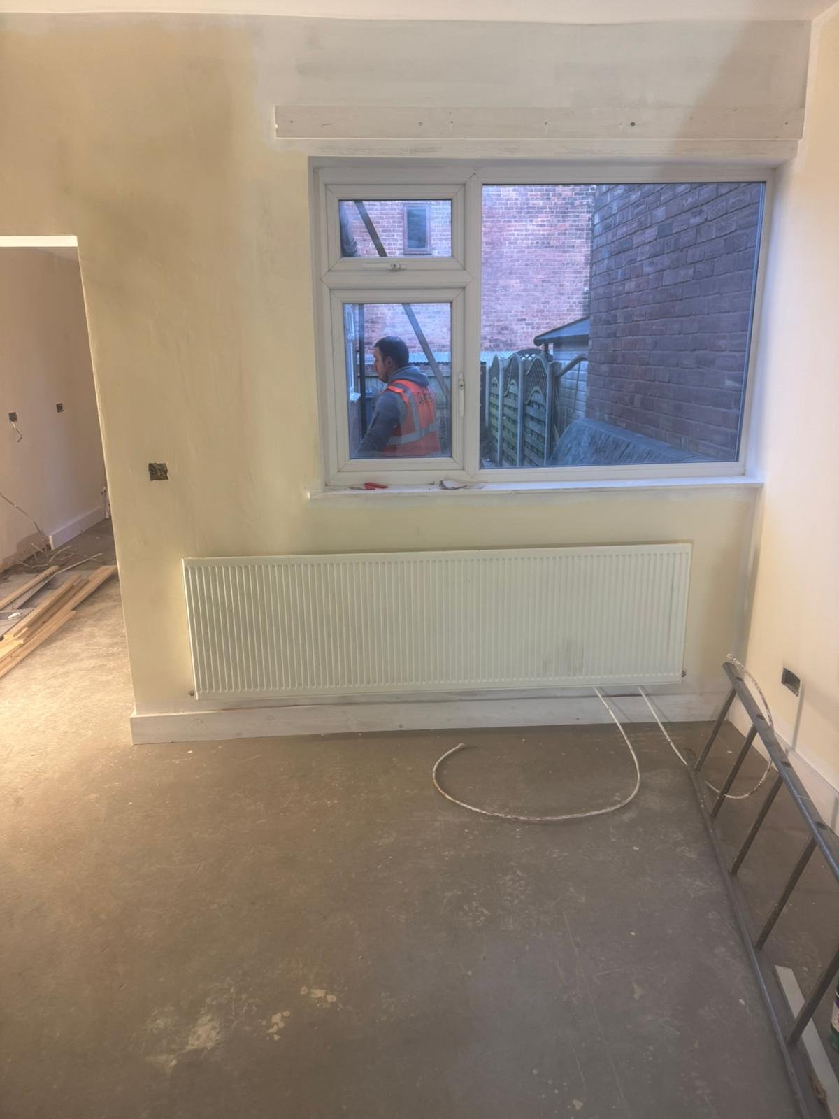 Room with a newly screeded floor over a liquid damp-proof membrane, finished smooth and level