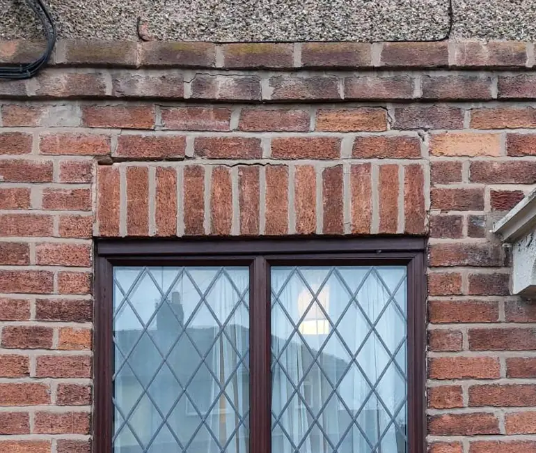 Cracks in the brickwork just above the soldier course over a window
