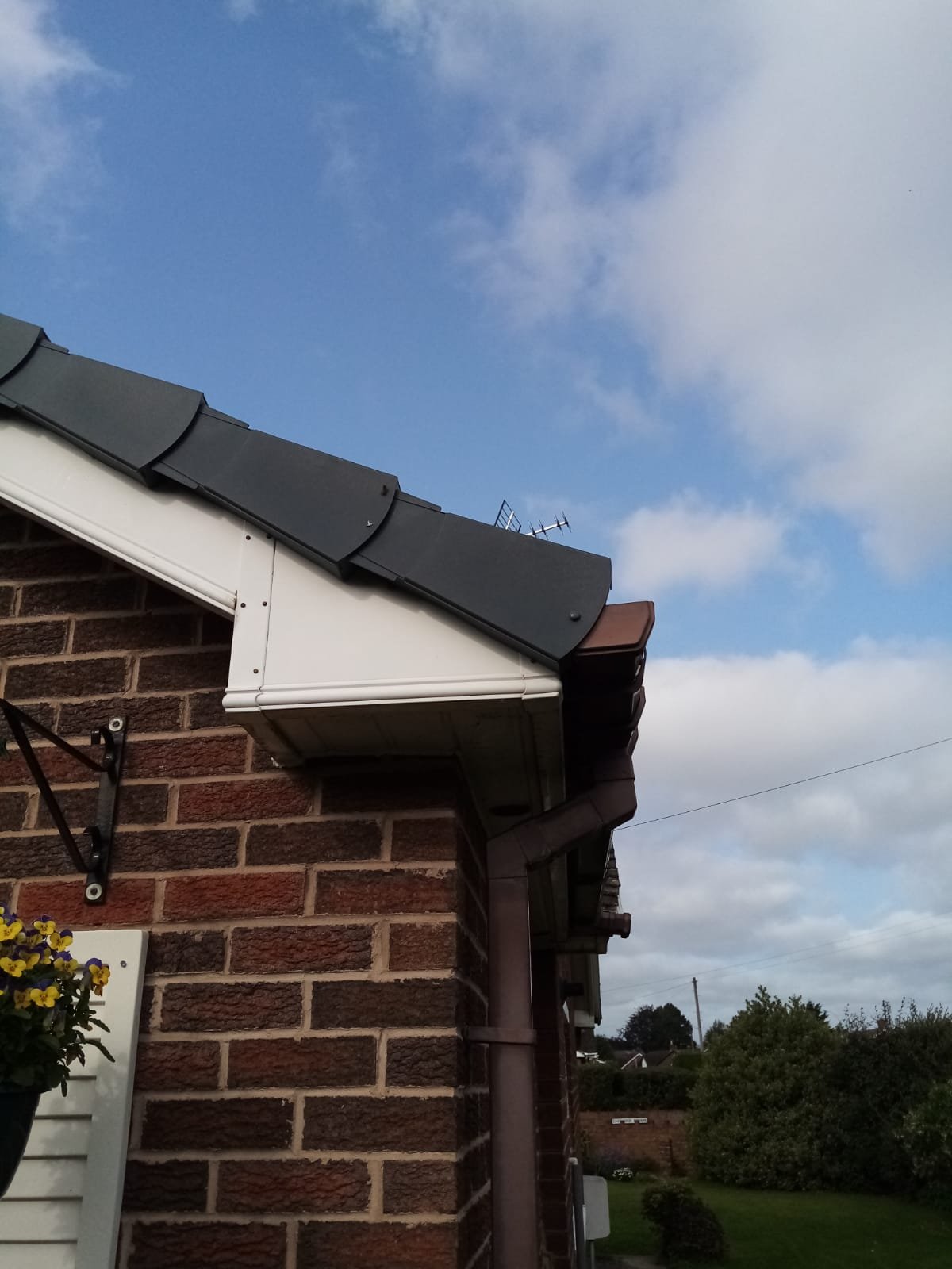 Mechanically fixed anthracite dry verge running down the gable towards the eaves