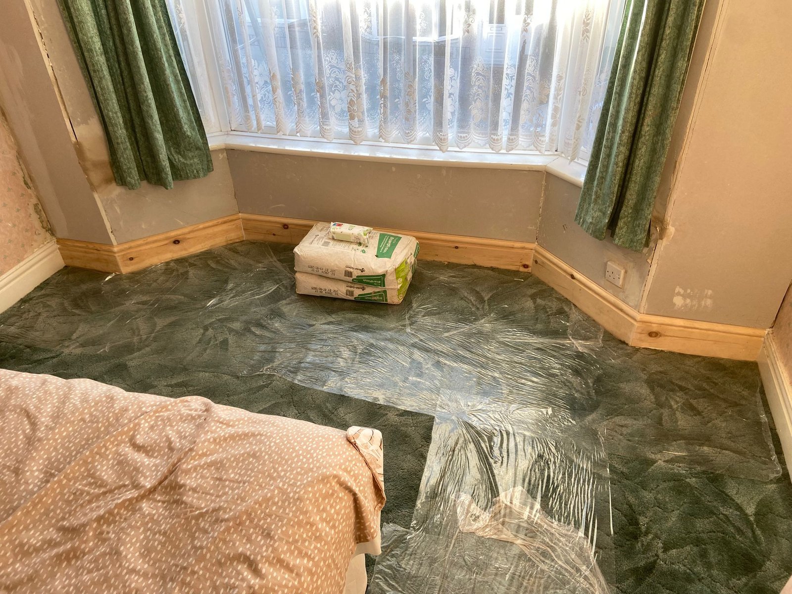 Bay window room replastered below the window with new skirting board fitted after crack stitching and restraint works