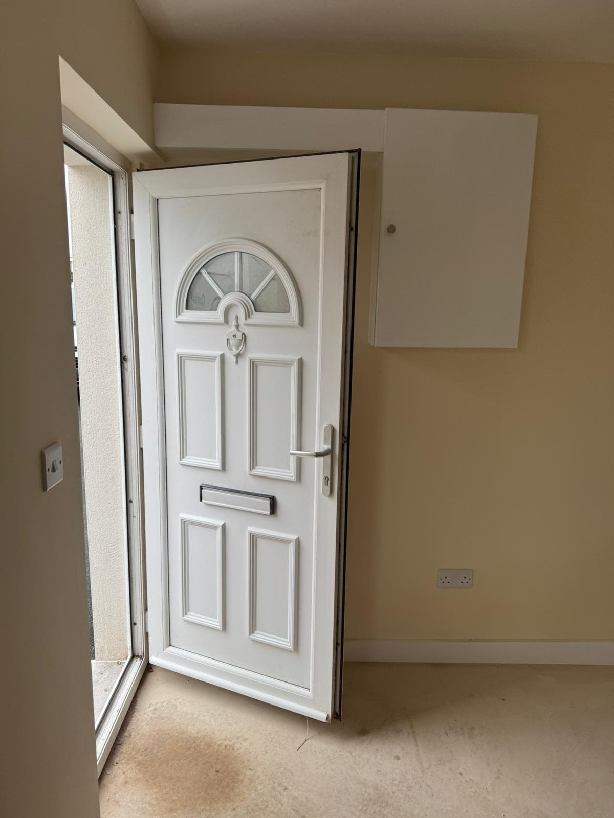 Screeded hallway floor over a liquid damp-proof membrane in a Flintshire house, level through to the front door
