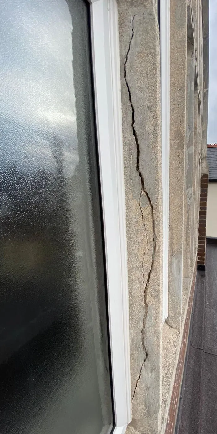 Crack running down the render beside a first-floor window