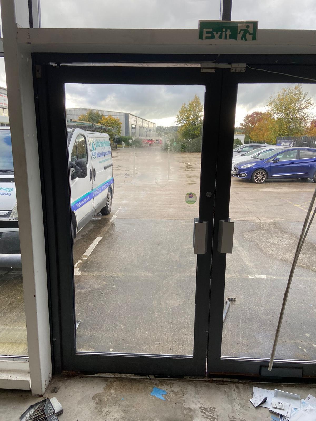Quirks technician inspecting and repairing fire exit door hardware