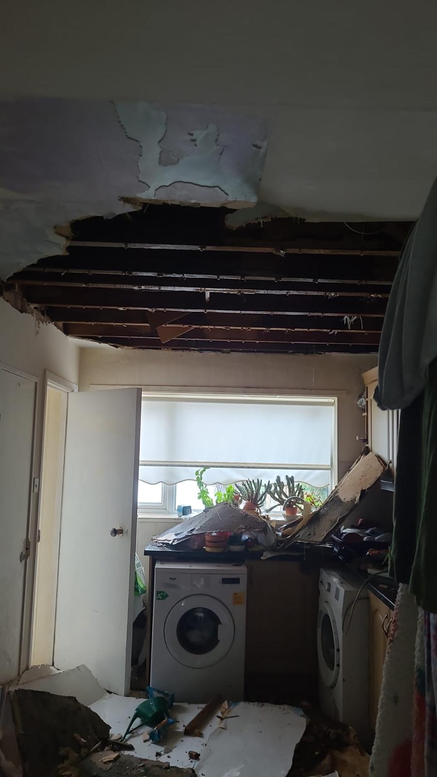 Collapsed kitchen ceiling with the joists exposed after water damage