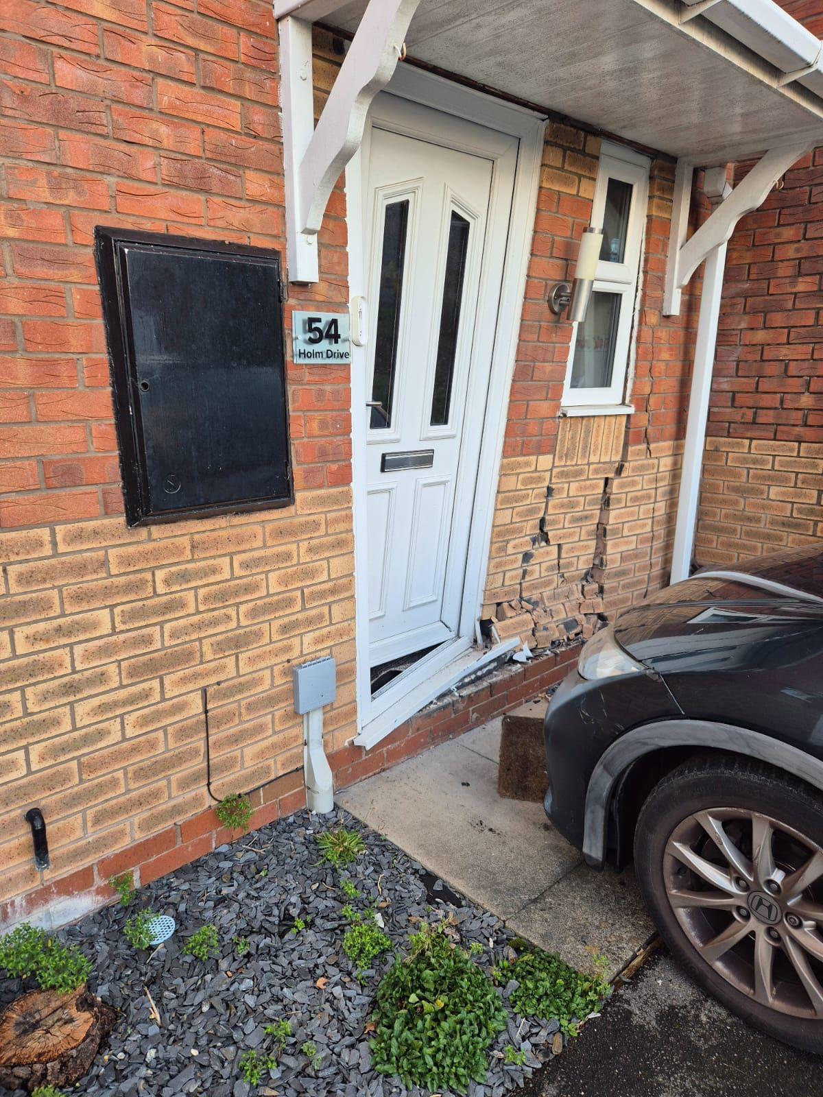 Damage to the front entrance of a brick house following the incident