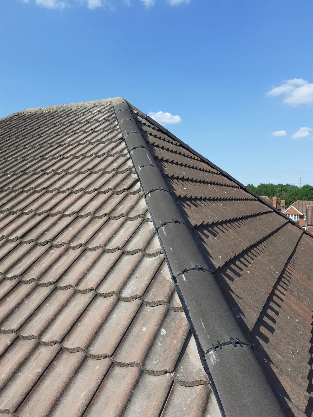Tiled pitched roof seen along its length from the ridge