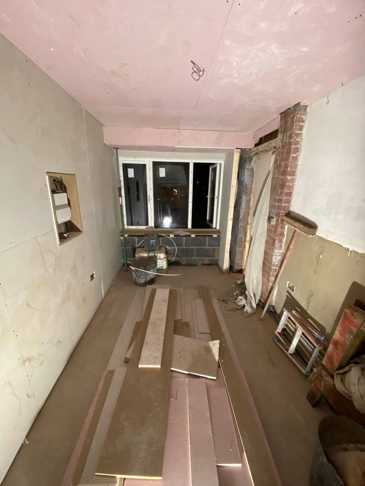 Converted garage interior boarded out with insulated plasterboard to the walls and plasterboard to the ceiling