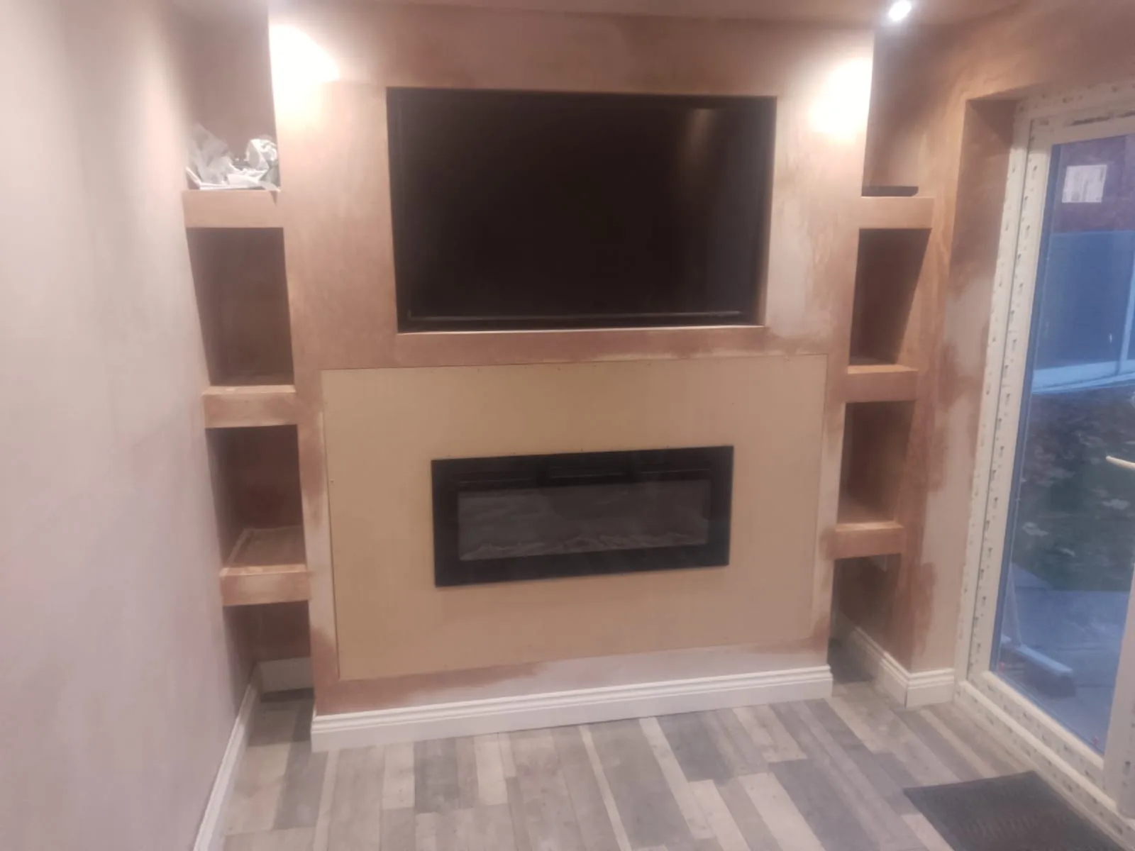 Media wall with recessed television and electric fire in a converted garage