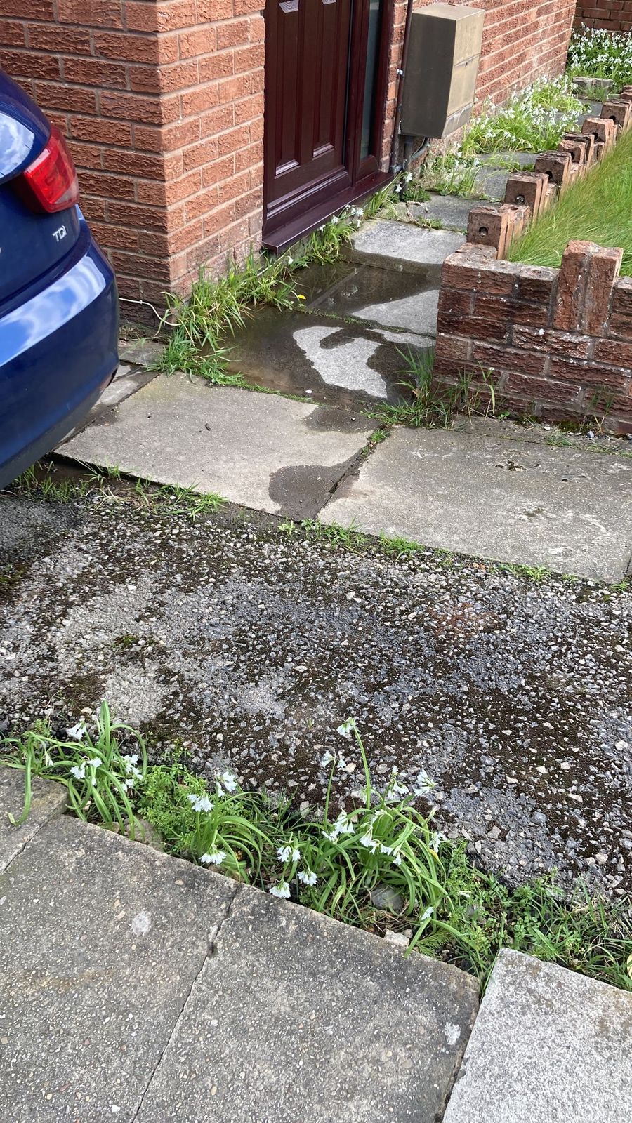 Water lying on the path at the front door of a house
