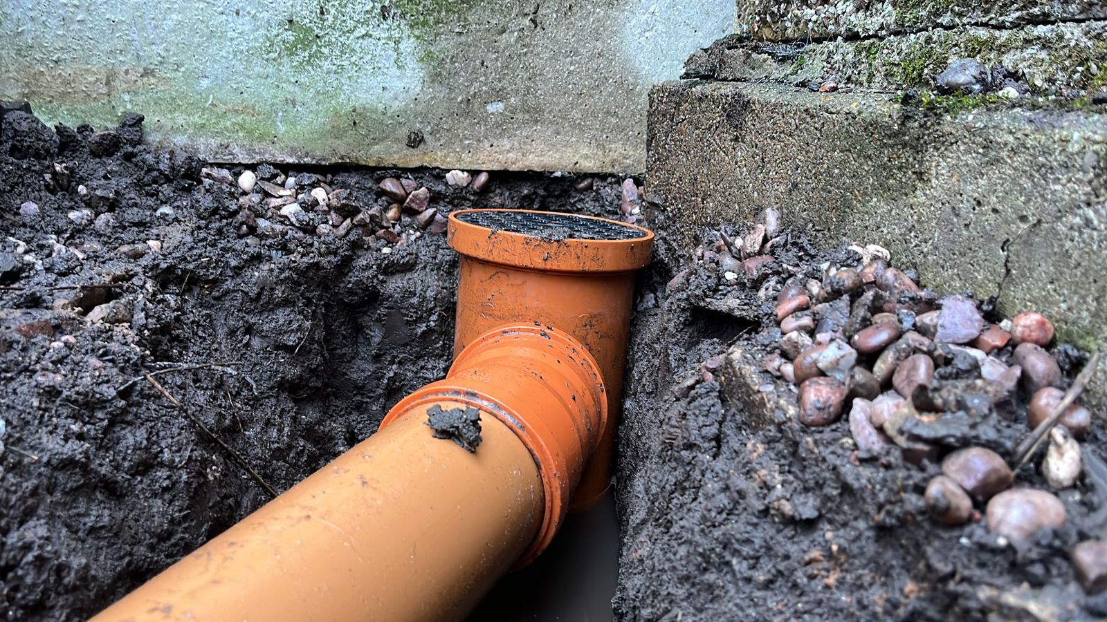 New gully and drain pipe laid in an excavated trench