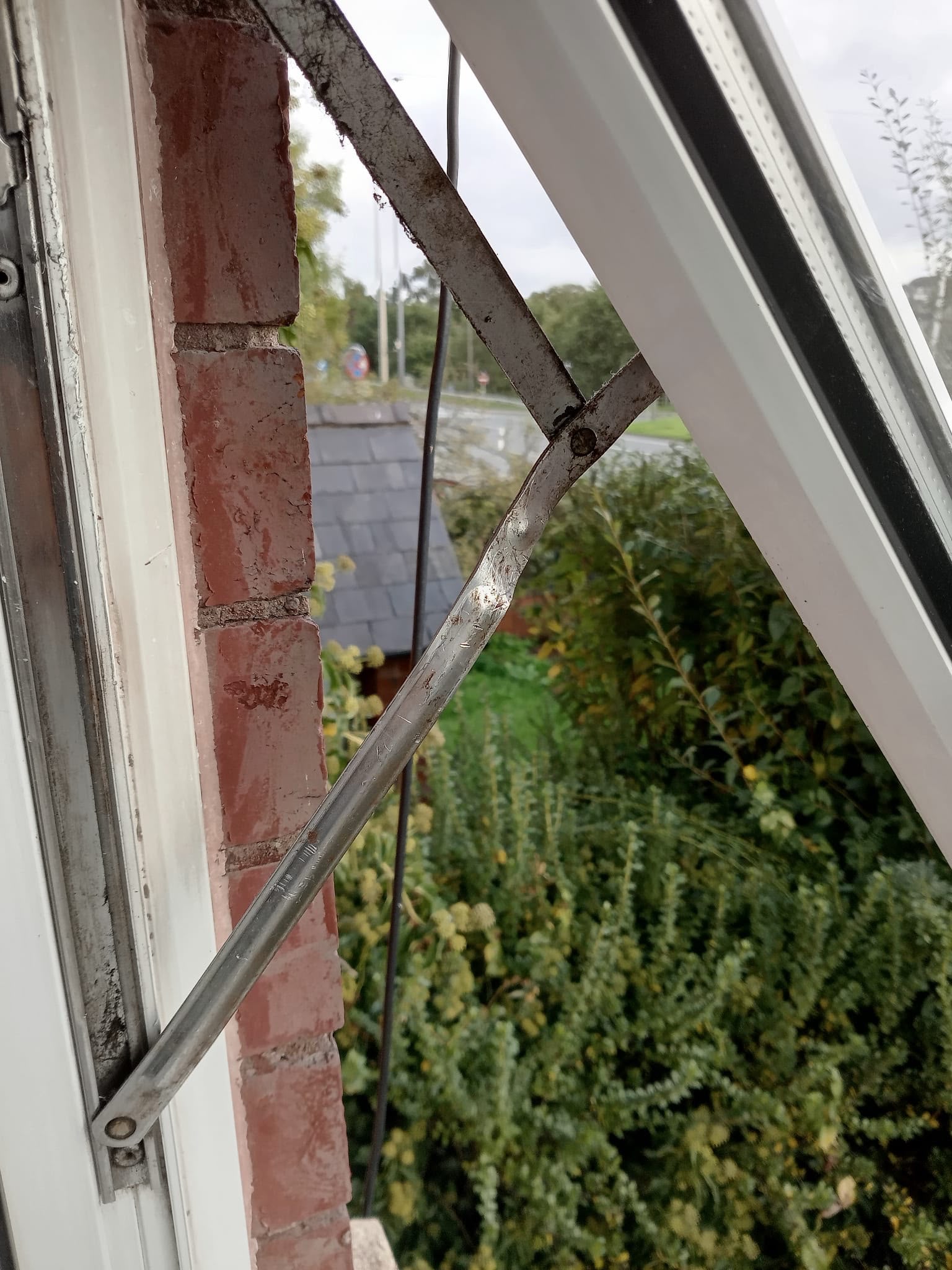 Timber door standing against a wall with its glazing unit shattered