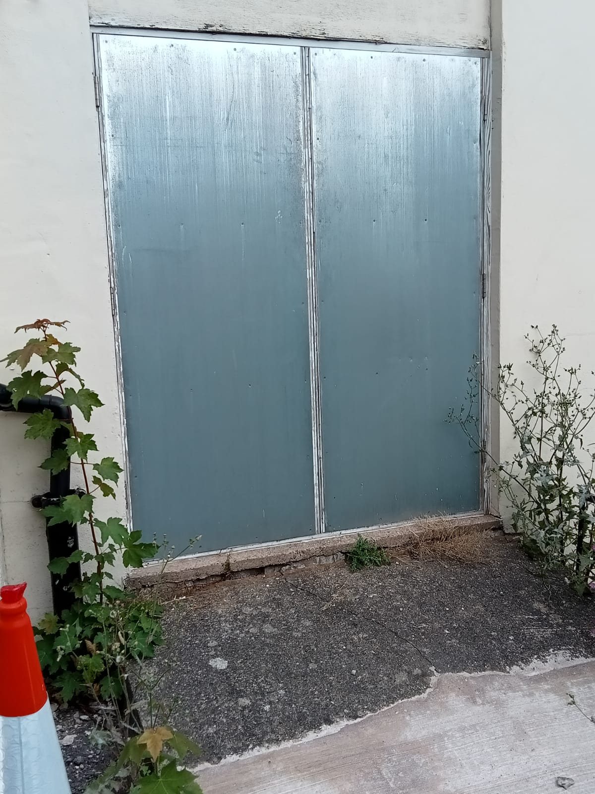 Pair of doors sheeted over in galvanised steel at a commercial building