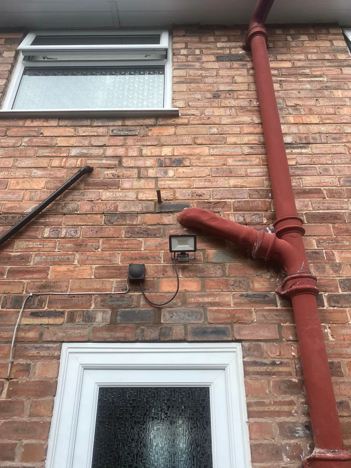 The finished head of a door opening, with the brickwork rebuilt and repointed above the frame