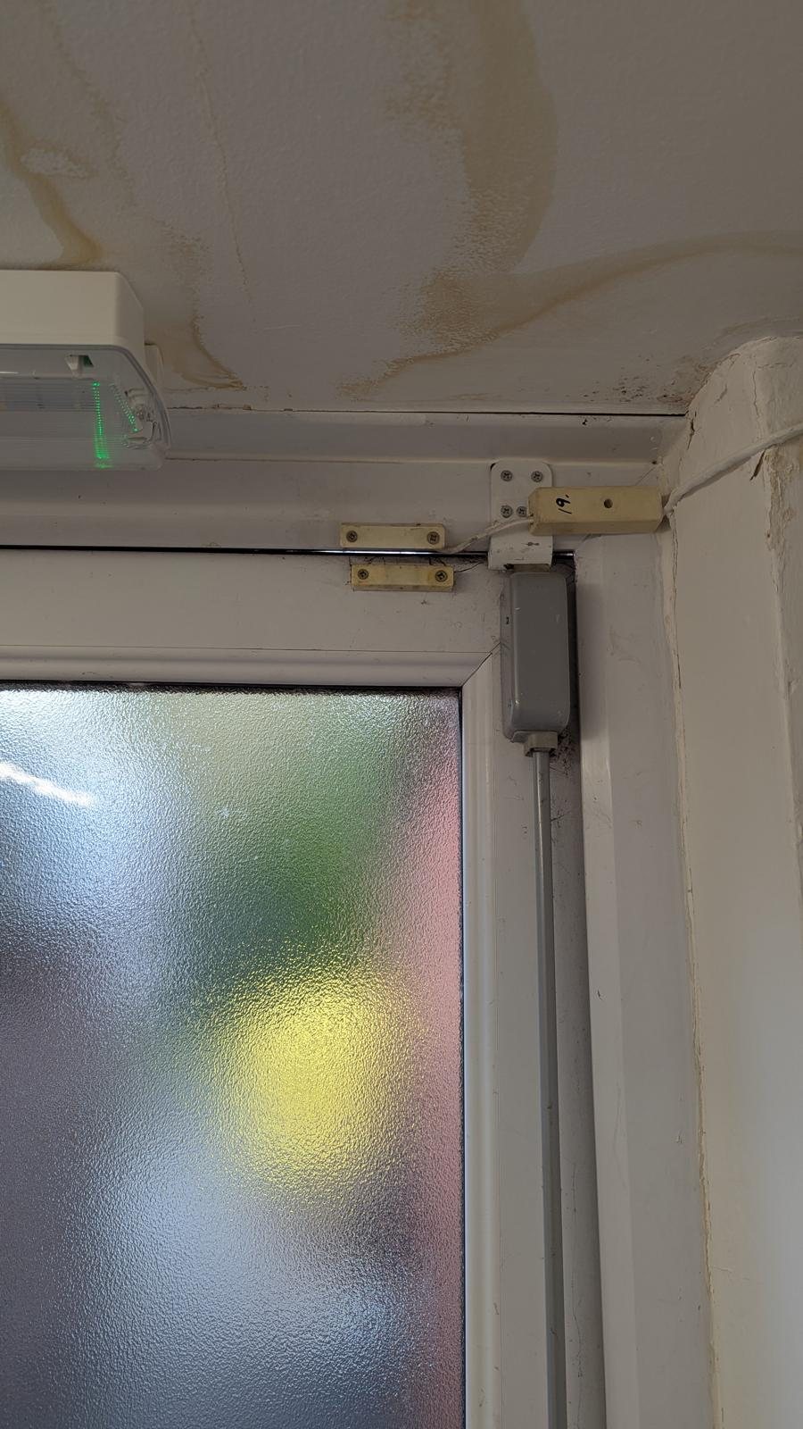 Corner of a uPVC door frame showing the hardware and keep